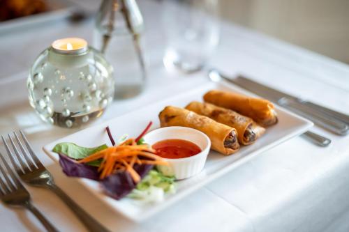 a white plate with food on a table at Kells Bay House and Gardens in Kells