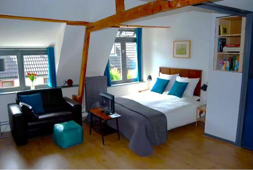 a bedroom with a bed and a chair and a desk at Apartement with terras in Amsterdam Noord in Amsterdam