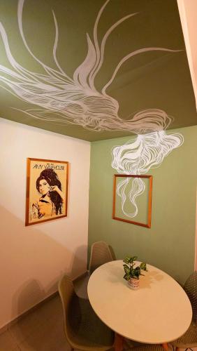 a dining room with a table and a painting on the ceiling at Solar Águas Pipa Prime in Pipa