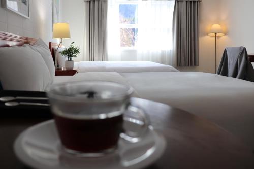 a cup of coffee on a table in a hotel room at August Jack Inn in Squamish