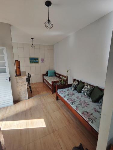 a living room with a couch and a bed at Villa Caiçara in Ubatuba