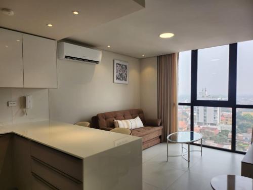 a kitchen and living room with a couch and a table at Modern Apartment Best in Town Equipetrol 1 to 5 guests in Hamacas