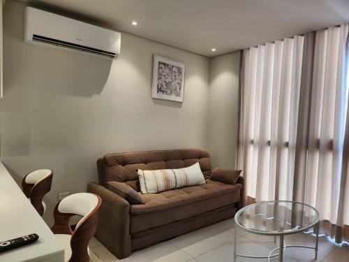 a living room with a couch and a glass table at Modern Apartment Best in Town Equipetrol 1 to 5 guests in Hamacas