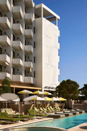 a hotel with a swimming pool with chairs and umbrellas at Ace Hotel & Swim Club Athens in Athens