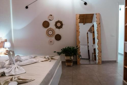 a bedroom with a bed and a mirror at Tropical Suite 22 A in Santa Maria