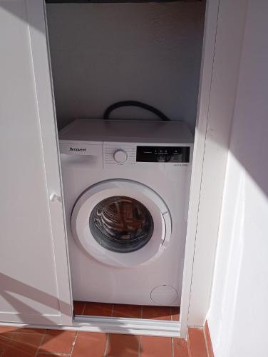 a washer and dryer in a white cabinet at Apartamento en Olvera con terraza in Olvera
