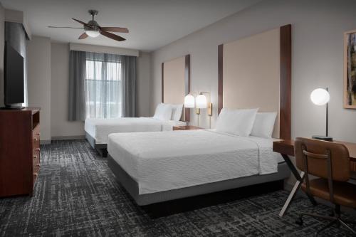 a hotel room with two beds and a ceiling fan at Homewood Suites by Hilton Seattle/Lynnwood in Lynnwood