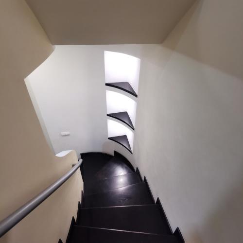 a spiral staircase in a building with a window at Big Apartment in Rivne center in Rivne
