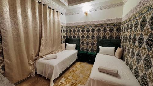 a room with two beds and a curtain at Appartement near to AirPort 262 avenue el khalij 2 BEDROOM in Marrakech