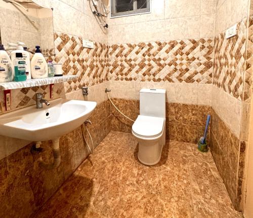 a bathroom with a toilet and a sink at PRIVATE Luxury Homestay in Khammam in Khammam
