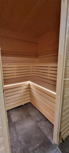 a sauna with wooden walls and a wooden ceiling at Chalupa Vápenka in Stárkov
