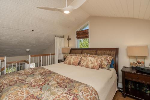 a bedroom with a bed and a ceiling fan at Makani Moana Loft - Golf Course View - North Shore - Sleeps 2 in Kahuku