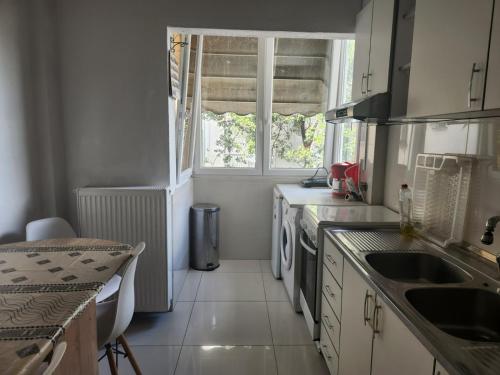 a kitchen with a sink and a window at Sea , Airport,Parking 56sqm Apt in Thessaloniki