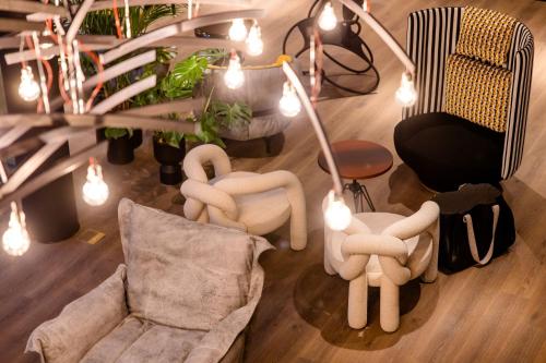 a living room with two chairs and a couch at Motel One Antwerp in Antwerp