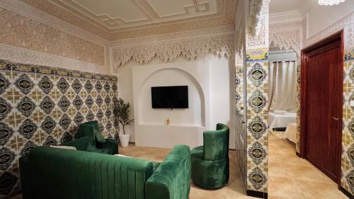 a living room with a couch and a tv on a wall at Appartement near to AirPort 262 avenue el khalij 2 BEDROOM in Marrakech