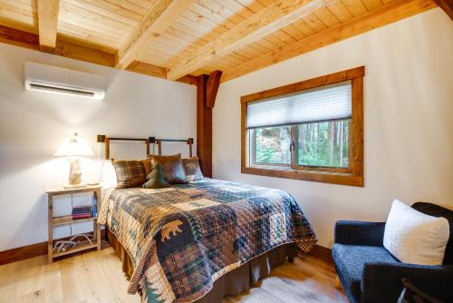 a bedroom with a bed and a window and a chair at Bear Lodge Waterfront Cabin with Level 2 EV Charger in Sutter Creek
