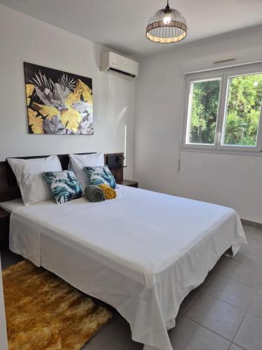 a bedroom with a large white bed in a room at Foyal Toloman - Flanboyan lodge in Les Trois-Îlets