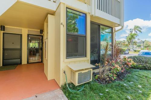 a house with a window and a air conditioner at Plumeria Tree Hale - Golf Course View - Sleeps 4 in Kahuku