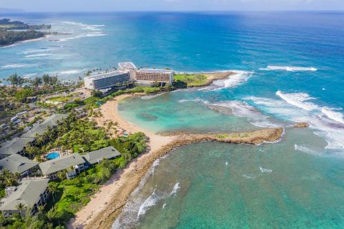 an aerial view of a resort on the beach at The Drifter - North Shore Loft - Relaxed Luxury in Kahuku