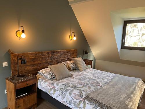 a bedroom with a large bed and a window at L’étable d’Auguste in Arreau