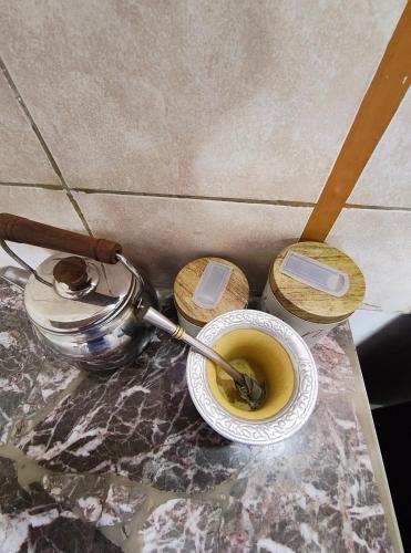 a cup of coffee with a spoon in it on a table at Hospedaje Don Felix in General Acha