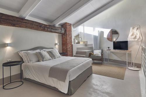 a bedroom with a bed and a living room at DORA maison de charme in Ivrea