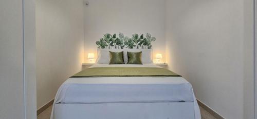 a bedroom with a large white bed with two pillows at Dionysus Luxury Villa in Brucoli