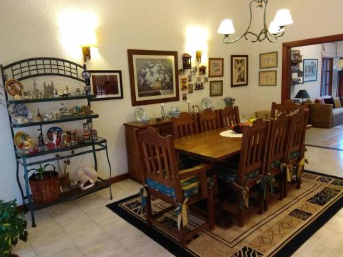 a dining room with a wooden table and chairs at Chalet ALTOS DEL PINAR in Punta del Este