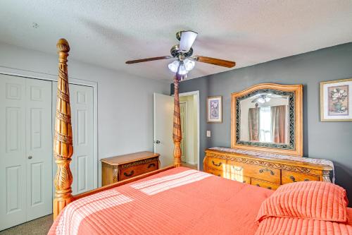a bedroom with a bed and a ceiling fan and a mirror at Near Fort Liberty Home with Yard in Fayetteville! in Fayetteville