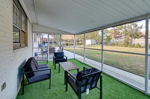 a screened in porch with chairs and a table at Near Fort Liberty Home with Yard in Fayetteville! in Fayetteville