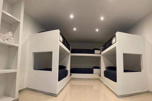 a room with three bunk beds in it at Río Celeste Poshtel Tayrona - Zaino in Calabazo