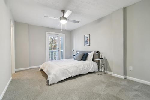 a white bedroom with a bed and a ceiling fan at Halsten At Vinings 2106 Spacious 2bd 15 Bth in Atlanta