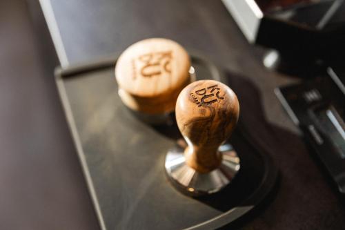 two wooden spoons sitting on top of a machine at Ace Hotel & Swim Club Athens in Athens