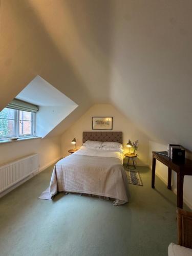 a bedroom with a large bed in an attic at 30 Park Street in Hungerford