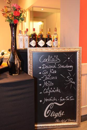 a chalkboard sign with bottles of wine on a table at Hotel The New Fox in Affligem
