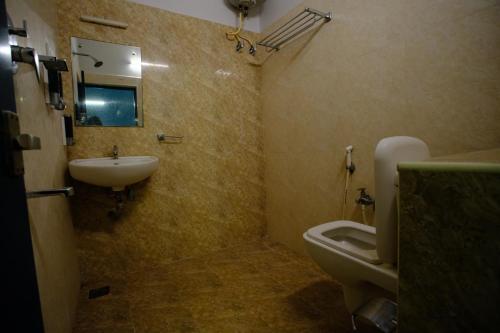 a bathroom with a sink and a toilet at Blue City Palace - Near Chennai Airport in Chennai