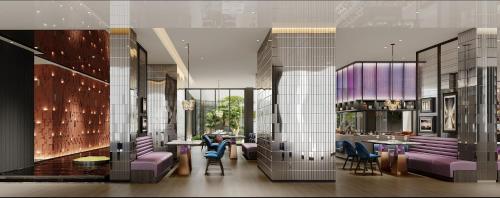 a lobby with purple chairs and tables in a building at Holiday Inn Zhengzhou Zhongzhou by IHG in Zhengzhou