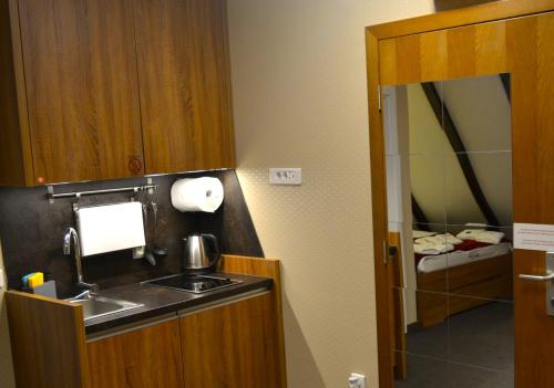 a small bathroom with a sink and a mirror at SKI MONTIS apartmani - Kopaonik centar in Kopaonik