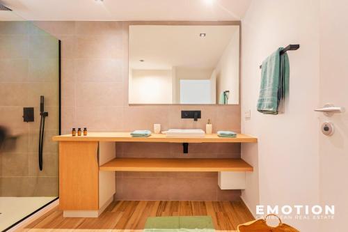 a bathroom with a sink and a mirror at Studio Alamanda Baie Orientale in Orient Bay