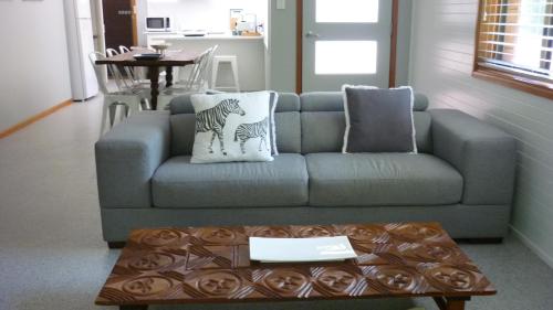 a living room with a couch and a coffee table at BILL'S in Coffs Harbour