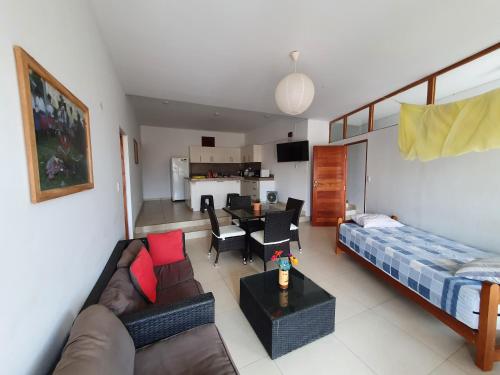a living room with a couch and a table at Casa El Maestro, Las Tortugas, Vichayito, Peru in Los Órganos
