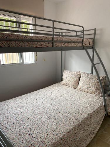 a bunk bed with two pillows on a bunk bed at Santa Ana in Novo Sancti Petri