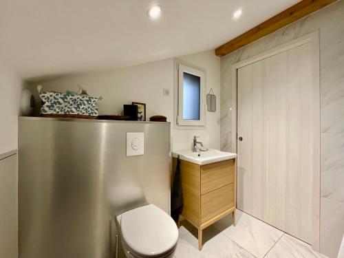 une petite salle de bain avec toilettes et lavabo dans l'établissement Le Grand Palatinat - Prestige & vue panoramique lac, à Gérardmer