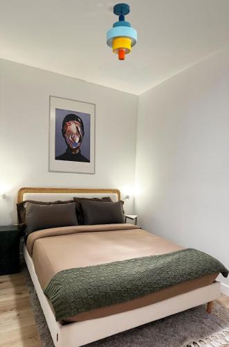 a bedroom with a bed in a white room at Modern, Remodeled Echo Park House-Walk to Sunset Blvd, Dodgers Stadium, Shops, Bars, Restaurants, Lake, Concerts in Los Angeles