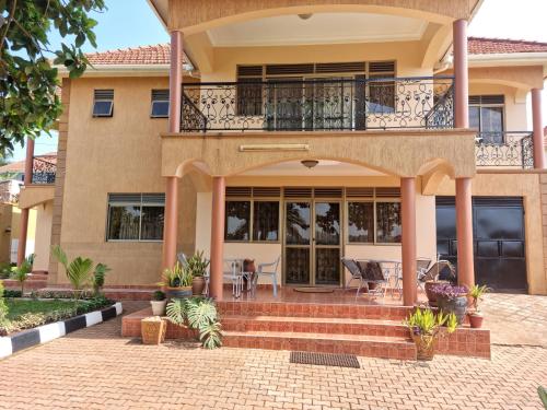 a house with a balcony and a patio at Akright Villa in Buzzi