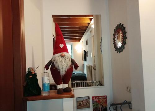 a gnome sitting on a shelf in a room at B&b del bosco e del lago Elimar in Lecco