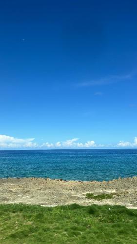 a view of the ocean from a beach at Coral House SAI in El Cove