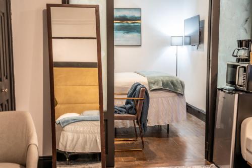 a mirror in a room with a bed and a chair at Mansfield in New York