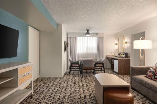 a living room with a couch and a table at Embassy Suites by Hilton Fort Lauderdale 17th Street in Fort Lauderdale
