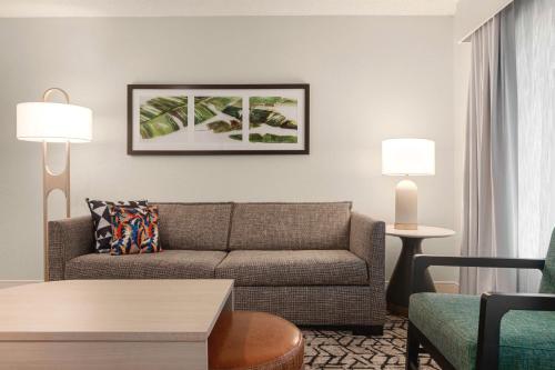 a living room with a couch and a table at Embassy Suites by Hilton Fort Lauderdale 17th Street in Fort Lauderdale